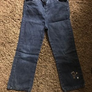 Blue jeans w/flower on bottom of leg